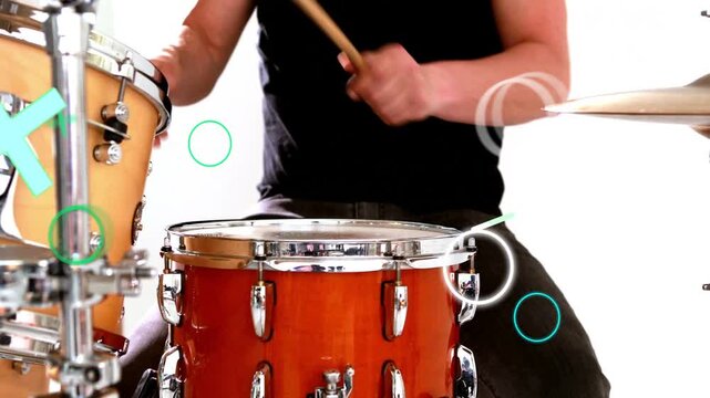 Drummer striking snare and playing fast ride groove for music as teal shapes overlaying kit