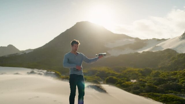 Slow Motion Man Taking Off and Flying Drone on Betty's Bay Sand Dunes, Remote Pilot in Cape Town South Africa