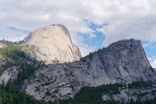 Iconic Half Dome and Liberty Cap granite peaks under a blue sky, Yosemite National Park, California, USA