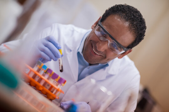 Smiling lab doctor and technician performing blood testing in a clinical laboratory setting
