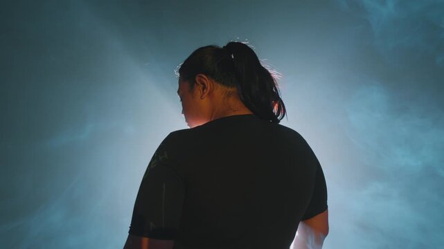 Silhouette of a Woman in Smoky Blue Light