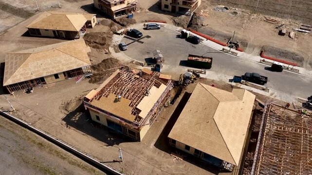 Aerial Orbit of a Busy Residential Housing Construction Site with Building Development Activity.