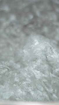 Bubbling boiling water creating effervescent carbonated bubbles in extreme close up