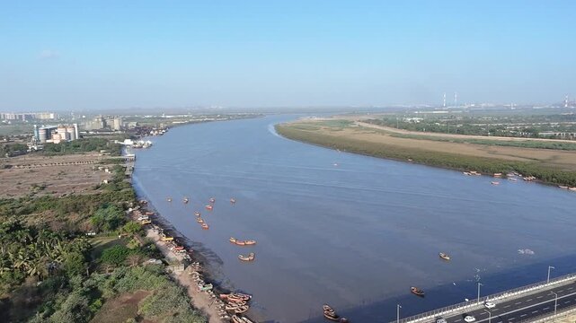 Curved Tapi River aerial landscape with boats and natural shoreline in Surat Gujarat India