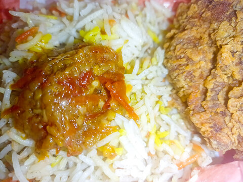 Traditional Arabic Mandhi Rice with Fried Chicken and Garnishes