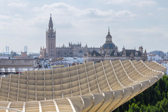 Seville, Andalusia, Spain &ndash; Feb 13, 2020: Panoramic view highlighting the modern Metropol Parasol structure, with the historic Seville Cathedral and Church of the Divine Savior visible over city rooft