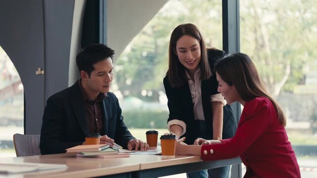 Group of multicultural business professionals collaborating in a productive team meeting, planning and analyzing data around a conference table
