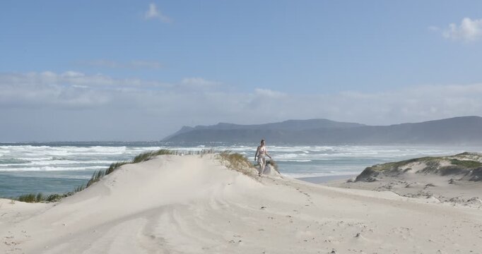 teens and children sand boarding dunes, Walker Bay Nature Reserve, Stanford, South Africa