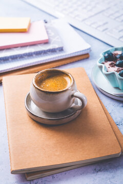 Small coffee breat with fresh jogurt with blueberries at desk, lunch in a office