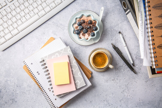 Small coffee breat with fresh jogurt with blueberries at desk, lunch in a office