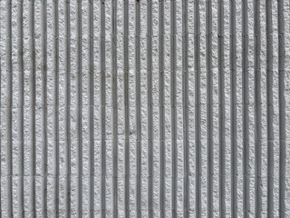 Seamless grey vertical fluted concrete wall texture, fluted cement facade background © Fariba