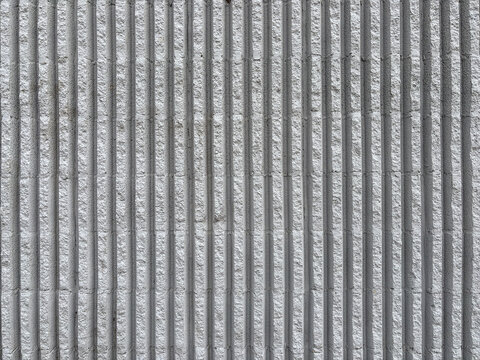 Seamless grey vertical fluted concrete wall texture, fluted cement facade background