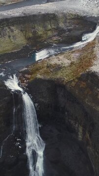 Epic Waterfall in scenic iceland nature, aerial shot - vertical video