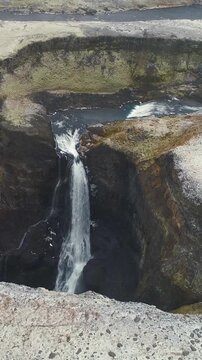 Epic Waterfall in scenic iceland nature, aerial shot - vertical video