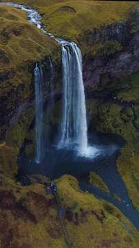 Epic Waterfall in scenic iceland nature, aerial shot - vertical video