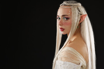 Naklejka premium Portrait of beautiful elf girl on black background, space for text
