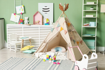 Cute wigwam and toys in stylish child's room © New Africa