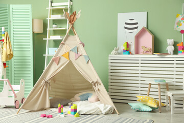 Cute wigwam and building blocks in stylish child's room © New Africa