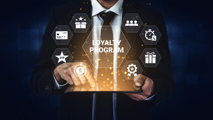 A businessman interacts with a tablet showcasing a loyalty program, highlighting features for...