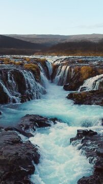 Epic Waterfall in scenic iceland nature, aerial shot - vertical video