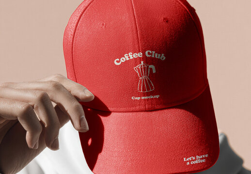 Cap with Embroidered Logo Held by Hand Mockup