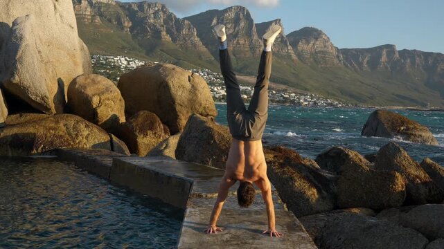 Slow Motion Shirtless Man Doing Handstand on Maiden's Cove Tidal Pool Wall, Sunset Fitness in Cape Town South Africa