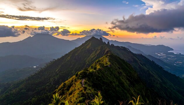 Mountain peak at sunrise with clouds.