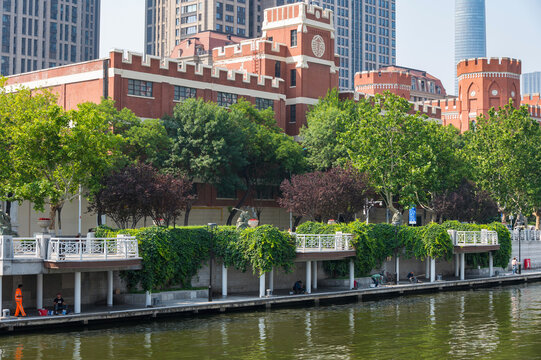 A striking view of Tianjin's waterfront, showcasing a blend of historic red-brick architecture and towering modern skyscrapers along the river. China 22 May 2025
