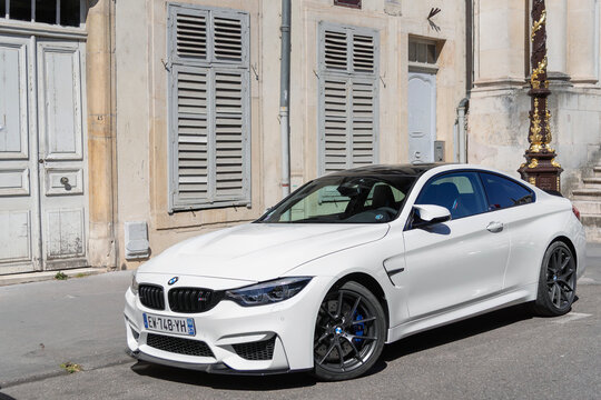 Nancy, France - May 30th 2020 : View on a white BMW M4 F82 finished in Alpine white parked on a street.