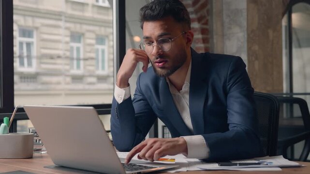 Arabian businessman Indian melancholy frustrated business man typing laptop in office stressed male guy Hispanic executive sleepy agent with computer boring work laziness trouble chronic depression