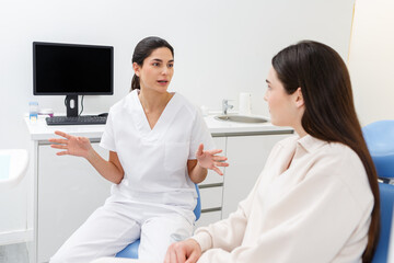 Doctor discusses treatment options with a patient in a modern clinic setting