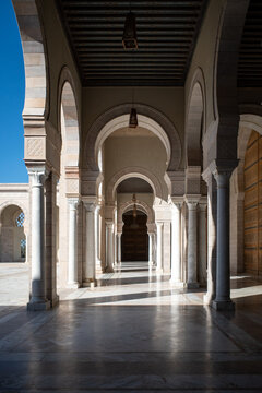 TUNIS, TUNISIA - APRIL 10, 2026: The rhythmic arched colonnade and sunlight patterns in the courtyard of the Malik ibn Anas Mosque in Carthage.