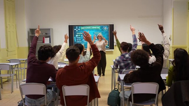 Active participation in a high school classroom. A teacher engages her students with an interactive whiteboard during a chemistry lesson