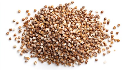 Naklejka premium Buckwheat kernels scattered on white surface, showcasing their brown and white hues.