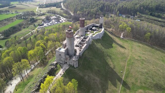 Chęciny - Kielce - Polska - Zamek Kr&oacute;lewski nagrany dronem. Kinowe ujęcia zamku na wzg&oacute;rzu wiosną, ujęcia zamkuj, las&oacute;w i G&oacute;r Świętokrzyskich