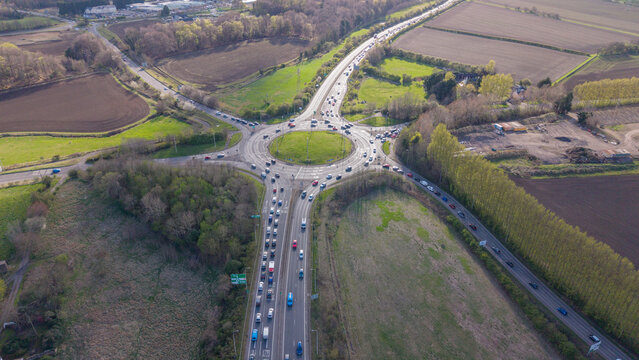 Bird's-eye view of the road infrastructure near the outskirts of Edinburgh. Aerial photography of the Sheriffhall junction surrounded by the landscapes of Midlothian and South East Scotland.