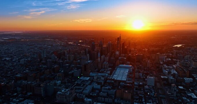 Golden hour in Philadelphia, Pennsylvania. Soft orange light covers the panorama of the vast city. Aerial view.