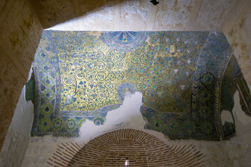 Damaged fresco detail inside Mor Gabriel Monastery, Mardin, Türkiye, featuring intricate patterns and religious motifs reflecting Syriac Orthodox cultural and spiritual heritage © osmanmaasoglu