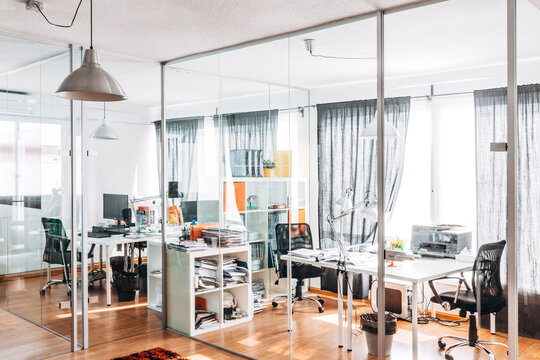 Modern glass office interior with desks and computers