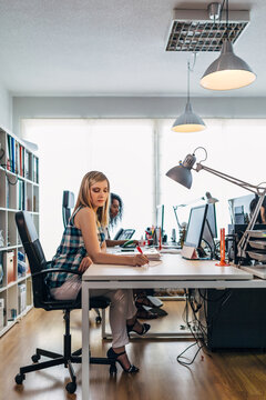 Modern office workspace with women working at desk