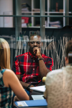 Thoughtful manager listening during office meeting discussion