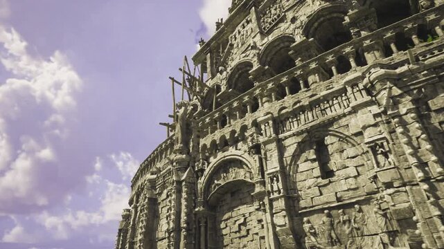 Ornate architectural details against cloudy skies. Editorial style shot highlighting elaborate facade features and dramatic cloudfilled background