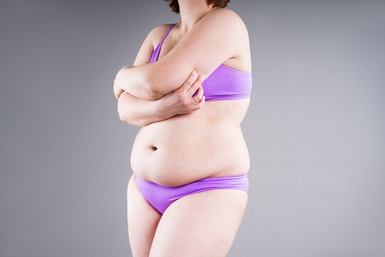 Overweight woman pinching armpit fat, weight loss and hand liposuction