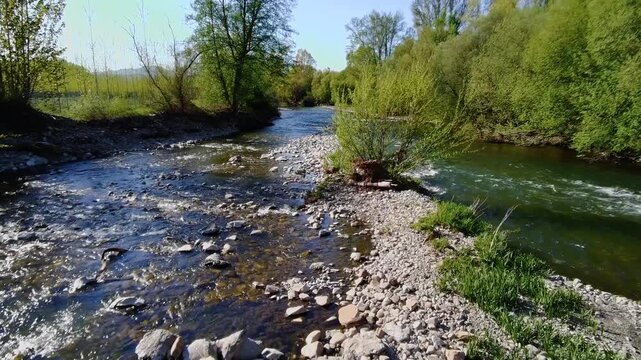Aerial view of the Sil River among the vegetation on the banks and a large number of submerged rocks in the center, carried by the force of the river due to floods and overflows