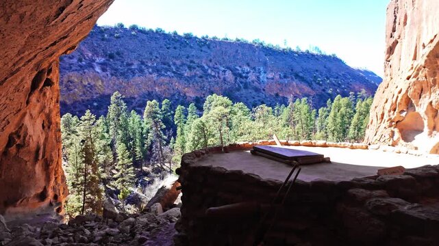 Scenic view of ancient settlements carved into rock cliffs at Bandelier National Monument in New Mexico