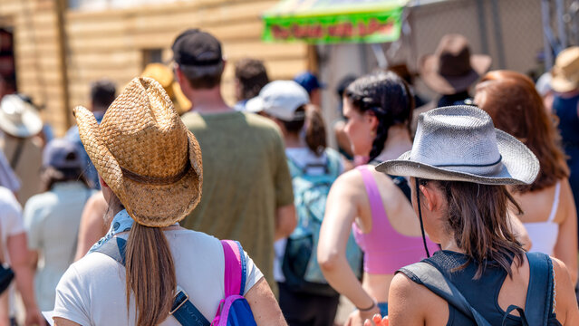 Calgary, Alberta - July 10, 2024: Group of people walking along Stampede Park