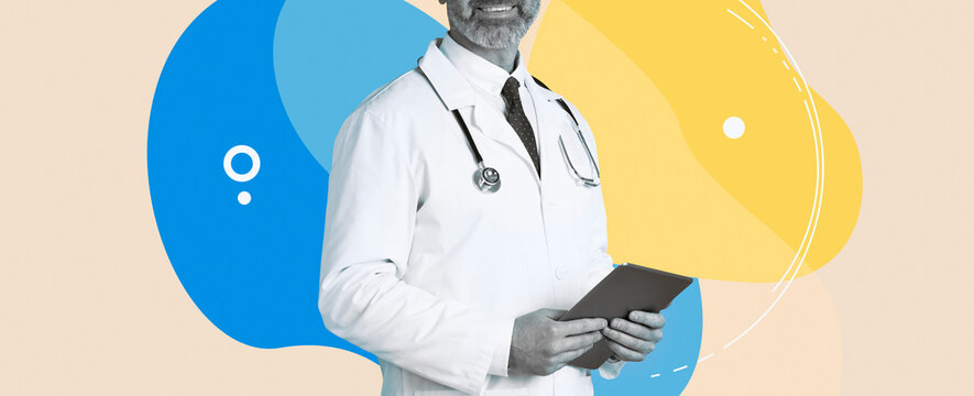 A doctor stands smiling while holding a digital tablet. He conducts remote appointments and provides medical advice, set against a blue background with copy space for text.