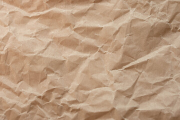 Fototapeta premium Crumpled brown kraft paper texture background with copy space. Eco, craft and packaging concept.