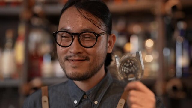 Night club concept of 4k Resolution. Asian male bartender smiling with confidence in liquor store.