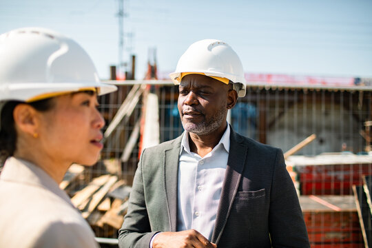 Construction managers discussing at building site